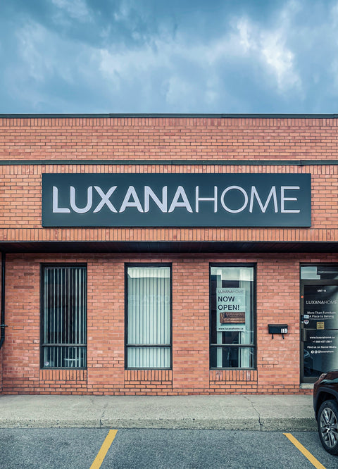 Storefront of Luxana Home, one of the best furniture stores near me, with a "Now Open" sign on the door.