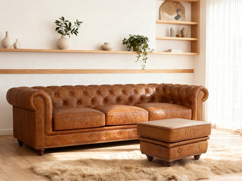 Stanhope Cognac Distressed Leather Chesterfield Ottoman in elegant living room setting.
