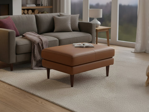 Selina Midcentury Tan Leather Ottoman in stylish living room setting, showcasing premium leather and elegant design.