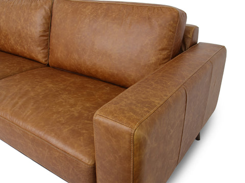 Amore Cognac Distressed Leather 3 seater sofa with teak oak legs and plush cushions in modern design.