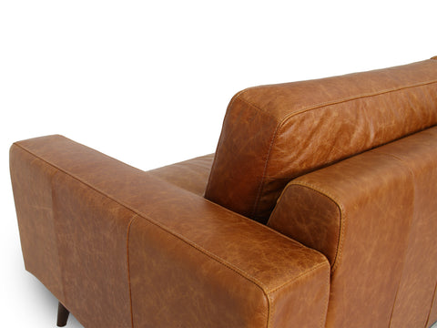 Side view of Amore Cognac Distressed Leather 3 seater sofa with modern craftsmanship and teak oak legs