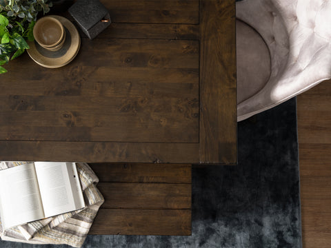 Top view of Annata Rustic Bench - Dark Solid Wood with a book and plush chair