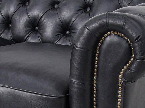 Close-up of Stanhope Black 3 Seater Chesterfield with aniline leather and nailhead trim, showcasing luxury upholstery details.