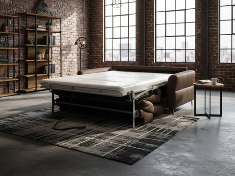Elena brown Leather Loveseat Sofa Bed in a modern industrial living space with a folded mattress.