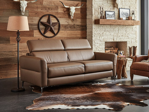 Elena brown Leather Loveseat Sofa Bed in a modern living room with rustic decor and a cowhide rug.