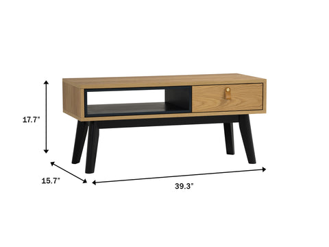 Lia Mid-Century Modern Oak Coffee Table with Drawer featuring Nordic design, black legs, and dimensions of 39.3x15.7x17.7 inches.