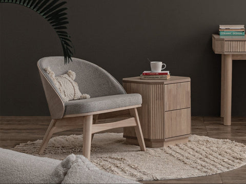 Lucca Modern Barrel Armless Chair in grey with wooden frame in a contemporary living room setting.