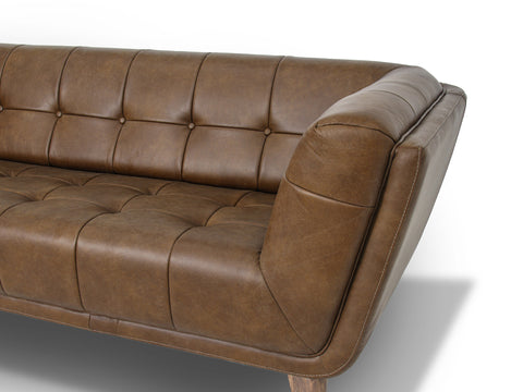 Mid Century Chestnut Brown Tufted Leather Sofa with geometric contours and flared arms, showcasing a grid-tufted backrest.