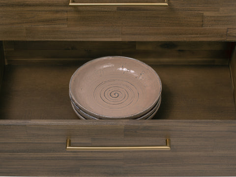 Open drawer of Nero Mid-Century Fluted Door Sideboard with Brass Handles displaying stylish dishes inside.