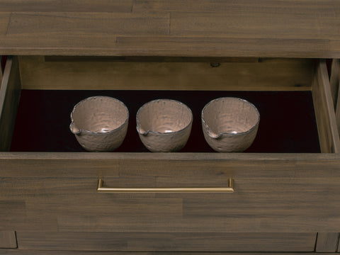 Nero Mid-Century Fluted Door Sideboard with Brass Handles drawer interior displaying three textured silver bowls.