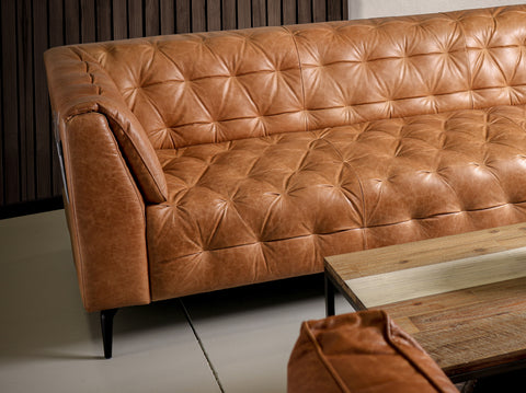 Nova Camel Brown Distressed leather 3 Seater sofa with deep button tufting and glossy black legs.