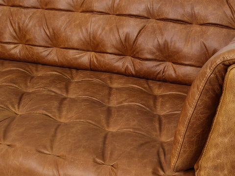 Close-up of the Nova Russet Brown 3 Seater Distressed Leather Sofa featuring deep button tufting and rich leather texture.
