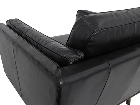 Selina Midcentury Black Leather Accent Chair close-up of backrest and plush cushions.