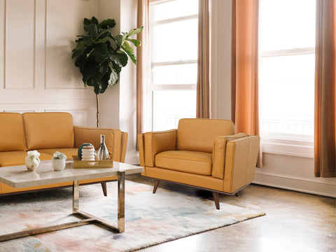 Selina Midcentury Cognac Leather Accent Chair in a stylish living room with modern decor and warm tones.
