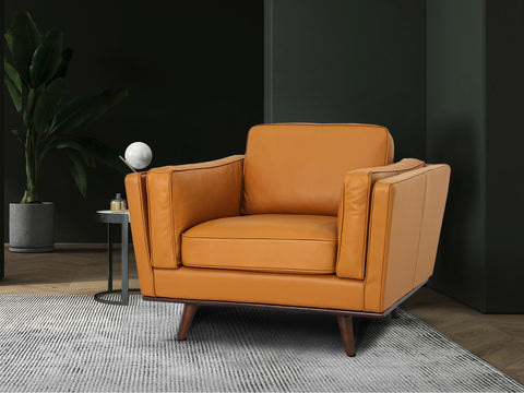 Selina Midcentury Cognac Leather Accent Chair in a modern living space with greenery and stylish decor.
