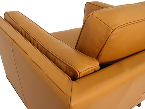 Selina Midcentury Cognac Leather Accent Chair showing top view of the luxurious leather upholstery and armrest design.