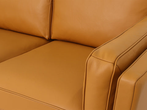 Close-up view of the Selina Midcentury Cognac Leather Loveseat Sofa showcasing its soft cognac leather upholstery.