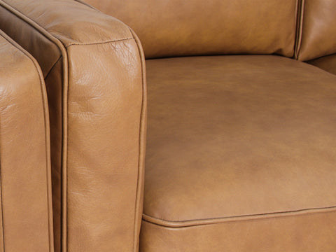 Selina Midcentury Tan Leather 3 Seater Sofa close-up view showcasing soft leather and cushion details.