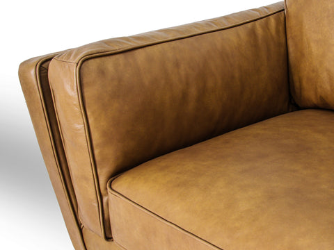 Selina Midcentury Tan Leather 3 Seater Sofa close-up of the cushion and armrest, showcasing the soft leather finish.
