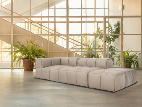 Tuscono Leather Beige 2 seater Single Lounge Modular Sofa in a stylish modern living space with plants.
