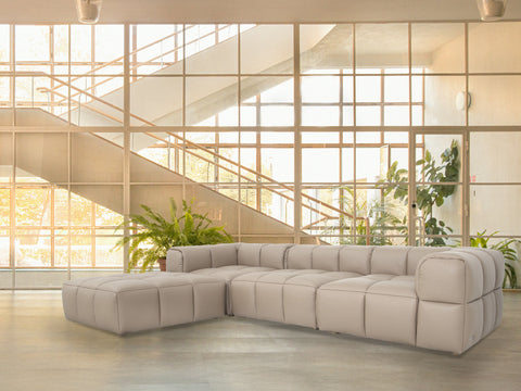 Tuscono Leather Beige 3 Seater Sectional Modular Sofa in modern interior setting with glass wall.