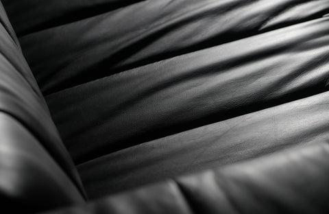 Close-up of a black leather sofa showing texture for article on How to Fix Scratches on a Leather Sofa.