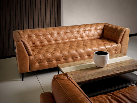 Solid Wood Frame Leather Sofa in a modern living room setting with a matching coffee table and armchair for stylish comfort.