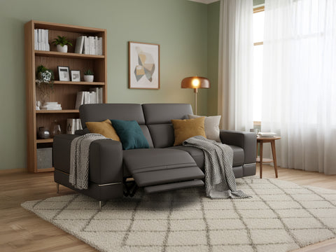 Modena Grey Leather Motorized Loveseat Recliner in modern living room setting with cozy cushions and natural lighting.