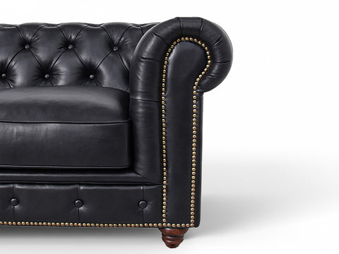 Close-up of Stanhope Black 3 Seater Chesterfield arm with black leather and studded detailing.