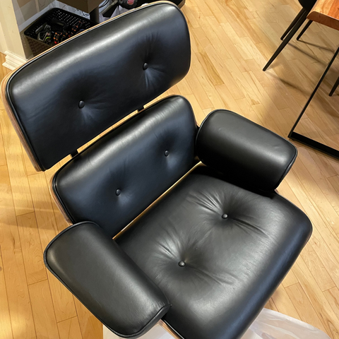 Black leather chair on a wooden floor 