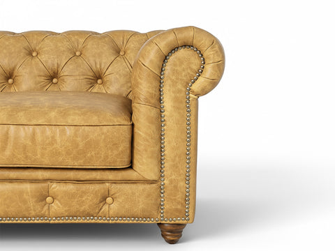 Close-up of Stanhope Camel Brown Distressed Leather 4 Seater Chesterfield with nailhead trim and tufted back