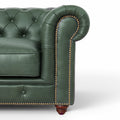 Close-up of the Stanhope Royal Green Leather 4 Seater Chesterfield showing tufted design and brass nailhead trim.