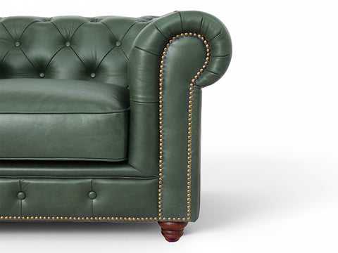 Close-up of the Stanhope Royal Green Leather 4 Seater Chesterfield showing tufted design and brass nailhead trim.