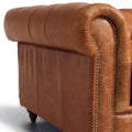 Side view of Stanhope Cognac Distressed Leather 4 Seater Chesterfield, showcasing luxurious aniline leather upholstery with nailhead trim.