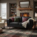Selina Mid-Century Leather Black Loveseat Sofa in cozy living room setting with burning fireplace and stylish decor.