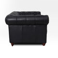 Side view of Stanhope Black Loveseat Chesterfield in rich top-grain aniline leather, highlighting British heritage style.