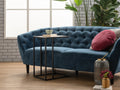 Amico Minimalist C-Shaped Laptop Table by blue sofa in modern living room with plants and decor