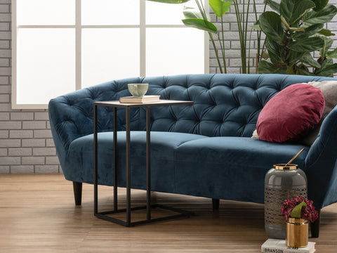 Amico Minimalist C-Shaped Laptop Table by blue sofa in modern living room with plants and decor
