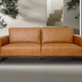 Amore Cognac Distressed Leather 3 seater sofa with tapered teak oak legs against a modern living room backdrop.