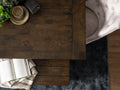 Annata Rustic Dining Table - Dark Solid Wood shown with open book and cozy setting