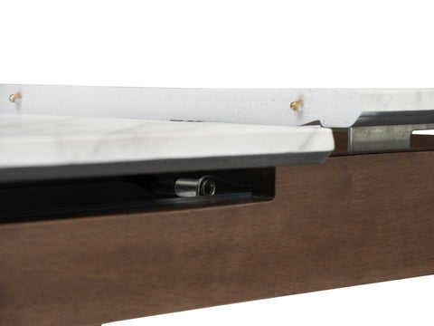 Close-up of Caldo Extendable dining table showing marble-look top and extension mechanism.