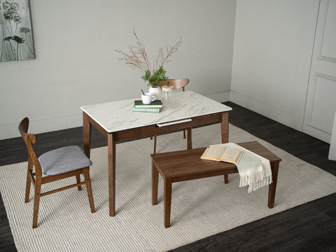 Caldo Extendable dining table with white marble-look top and cocoa oak legs in modern dining space.