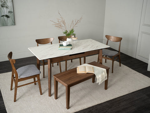 Caldo Extendable dining table set in a modern dining room with marble top and wooden chairs