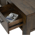Open drawer of Caro Rustic Coffee Table - Dark Solid Wood showcasing its storage space and craftsmanship.