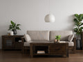 Living room with Caro Rustic Coffee Table - Dark Solid Wood, surrounded by sofa, plants, and decor, highlighting modern rustic style.