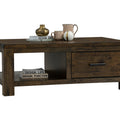 Caro Rustic Coffee Table - Dark Solid Wood with decorative items on top and open shelf display.