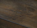 Close-up of Caro Rustic Coffee Table - Dark Solid Wood showcasing natural grain patterns and textures.