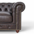 Close-up of Stanhope Dark Chocolate 3 Seater Chesterfield arm in rich aniline leather with tufted detailing and nailhead trim.