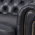 Close-up of Stanhope Black 3 Seater Chesterfield with aniline leather and nailhead trim, showcasing luxury upholstery details.
