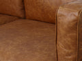 Close-up of Eleganza Cognac Distressed Leather 3 Seater Sofa with plush loose cushions and full top aniline leather texture.